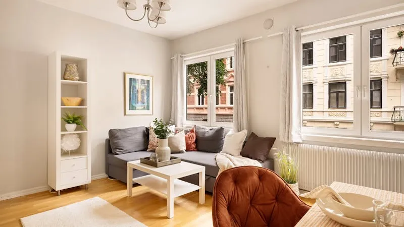 Bright staged apartment living room with minimal furniture